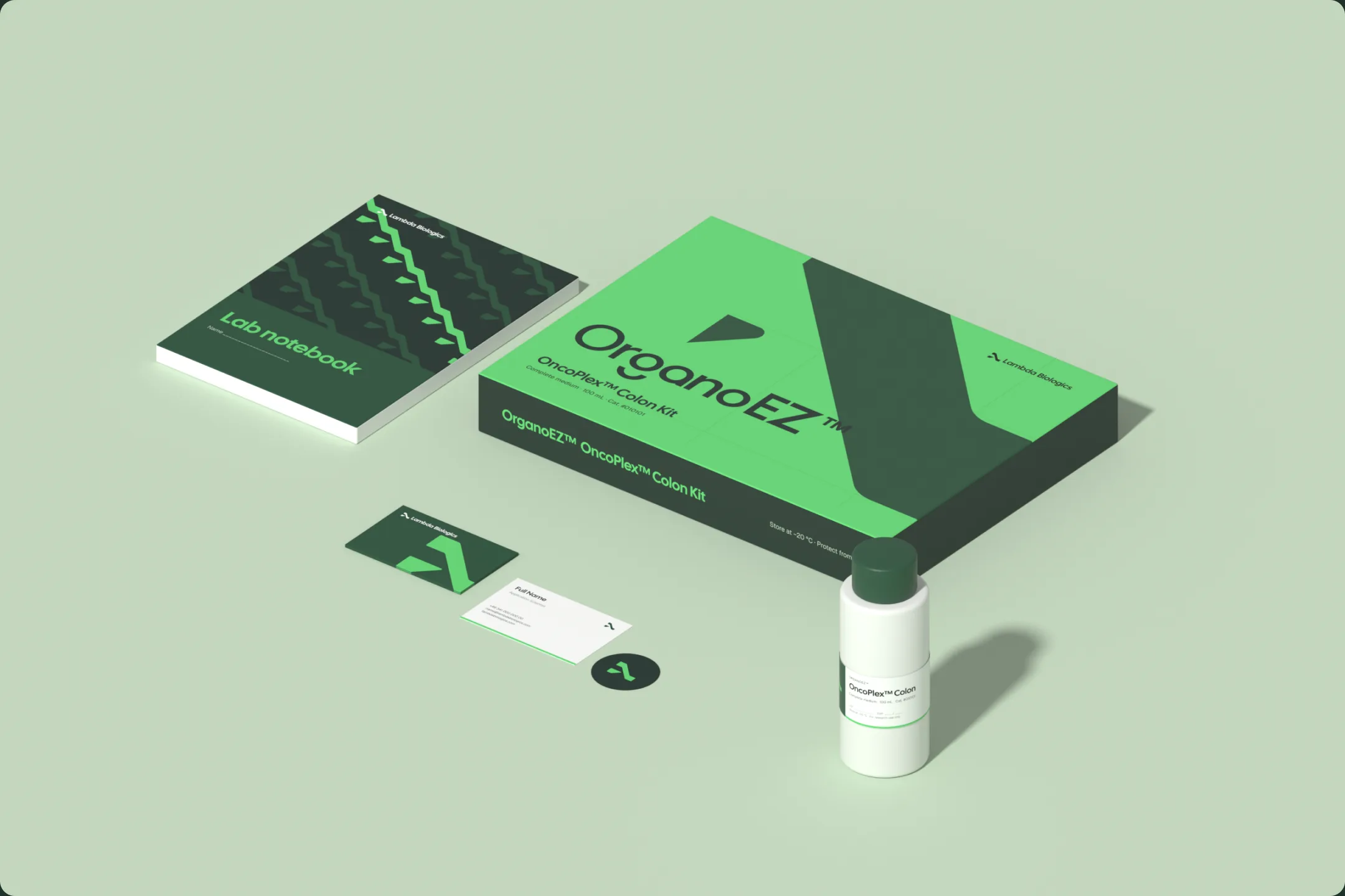 Rendered scene on pale green: the OrganoEZ kit box, the lab notebook, business cards, a seal sticker and a labelled bottle