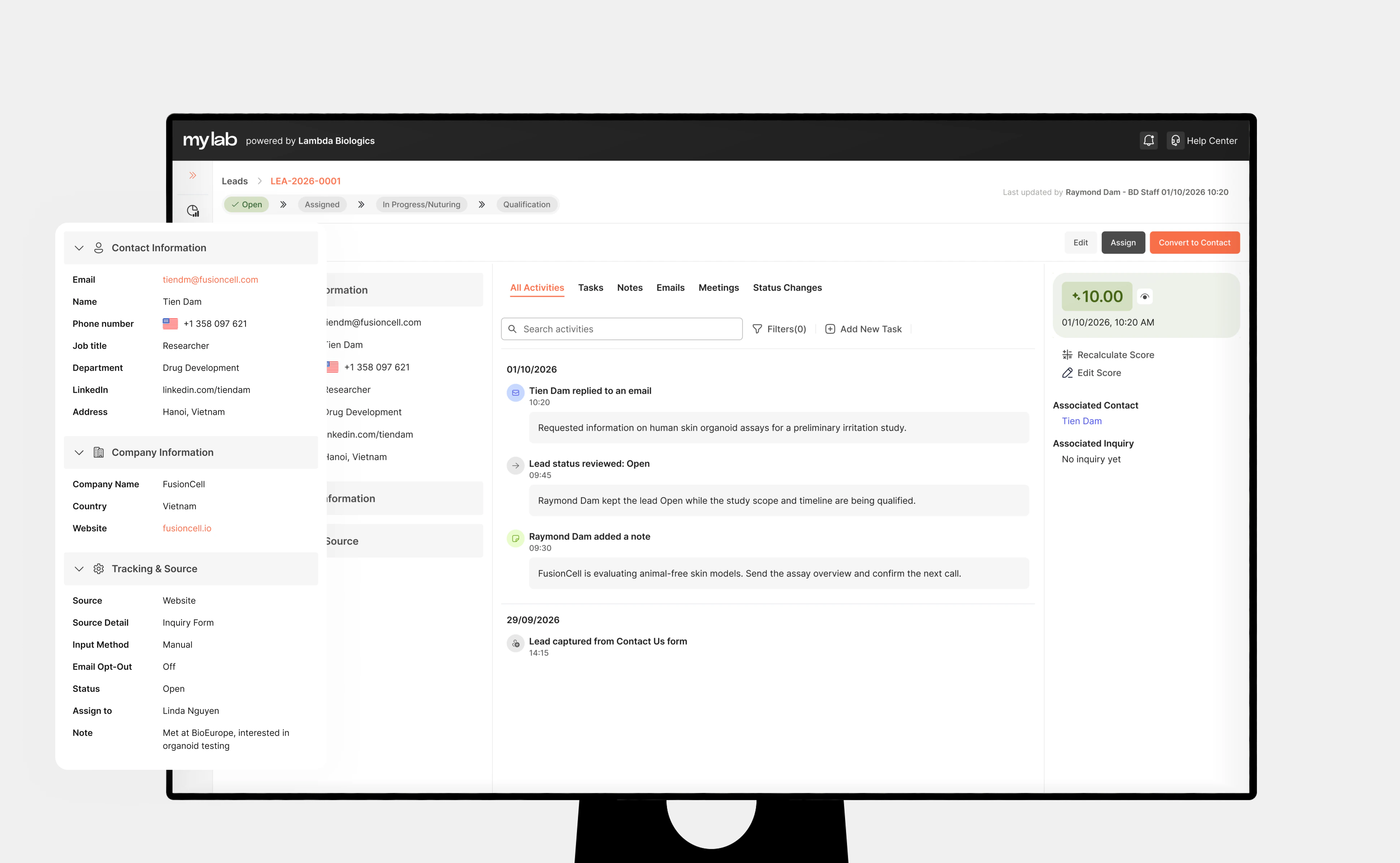 A MyLab CRM lead detail page on a monitor: the header with the lead's status steps and Edit, Assign and Convert to Contact actions, an activity timeline of emails, notes and status changes, and the lead score - with the grouped form pulled out beside it, its Contact Information, Company Information and Tracking & Source sections expanded